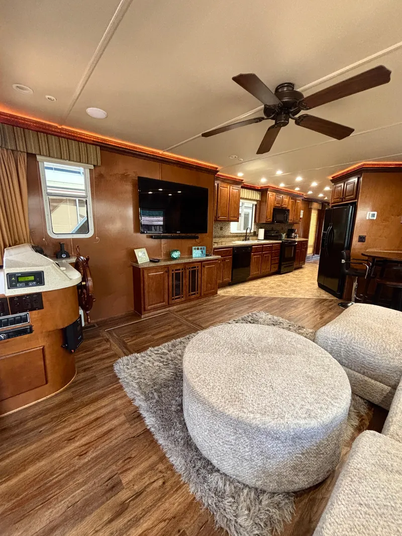 Slide: The Image of Luxurious 2012 Horizon 16x66 houseboat interior with modern kitchen, cozy seating, and entertainment area. - 24