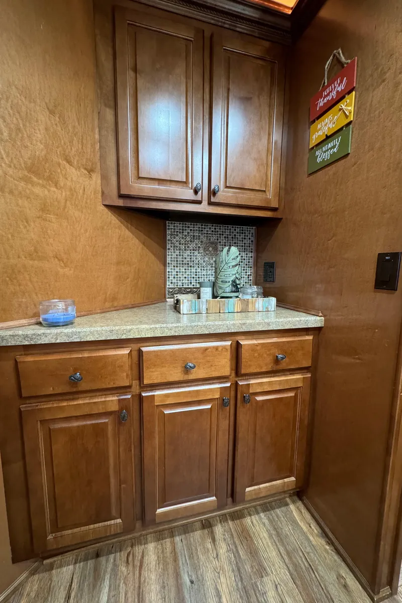 Slide: The Image of Wooden kitchen cabinets in a 2012 Horizon 16x66 houseboat interior. - 26