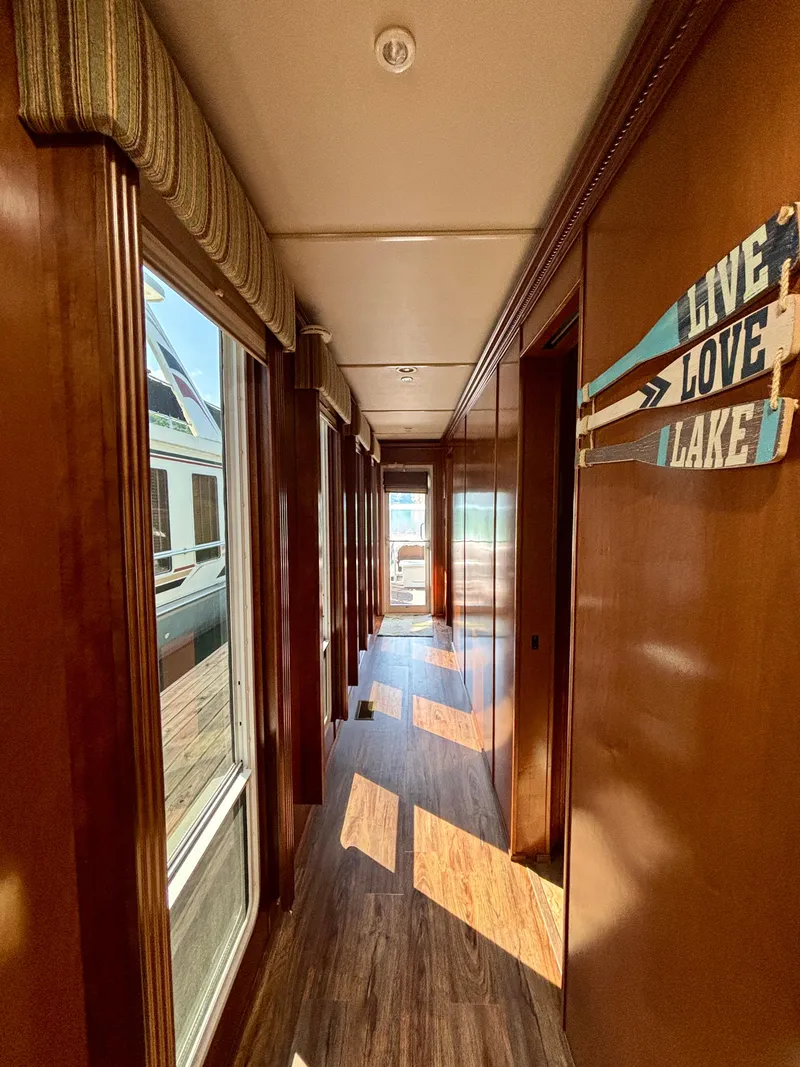 Slide: The Image of Hallway of 2012 Horizon 16x66 houseboat with wooden decor and lake-themed sign. - 29