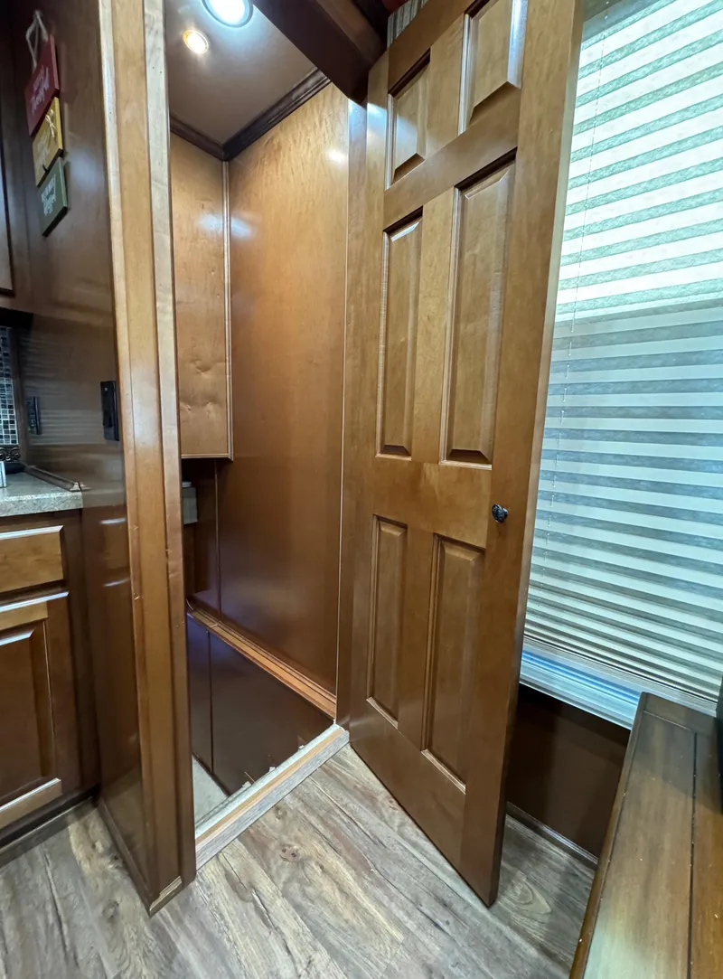 Slide: The Image of Interior of 2012 Horizon 16x66 with wooden cabinetry and flooring. - 30