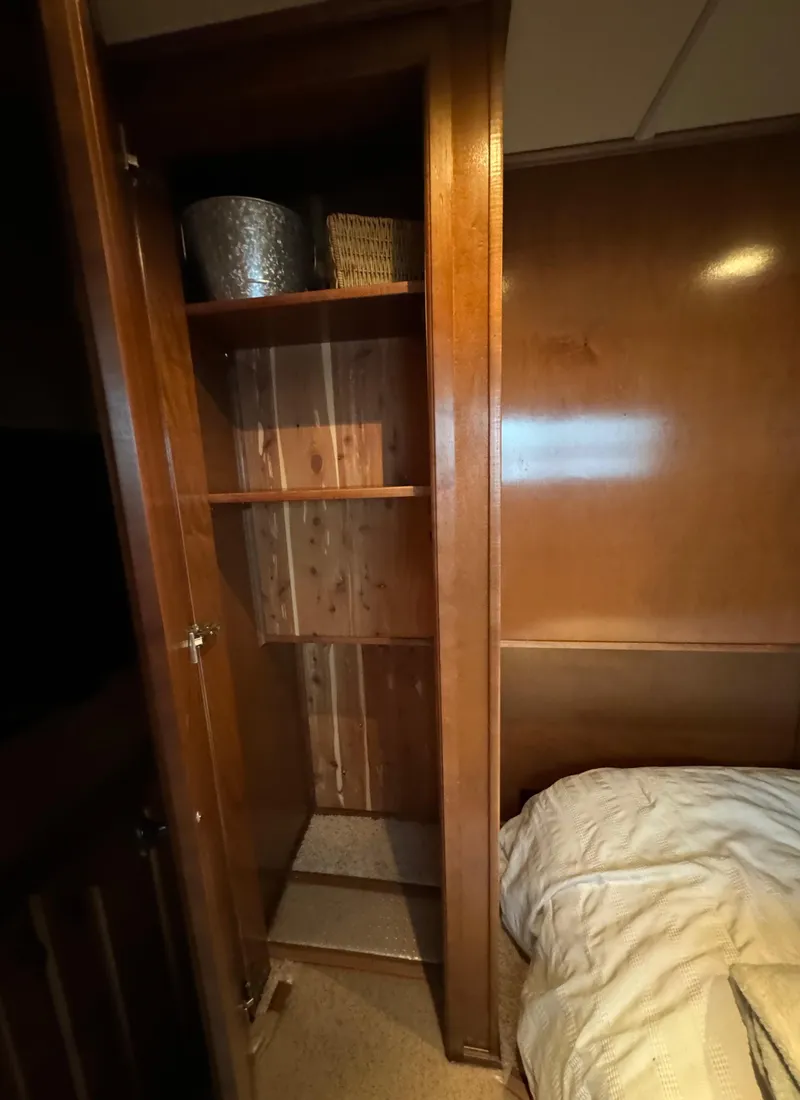 Slide: The Image of Wooden closet with shelves beside a bed in a 2012 Horizon 16x66. - 35