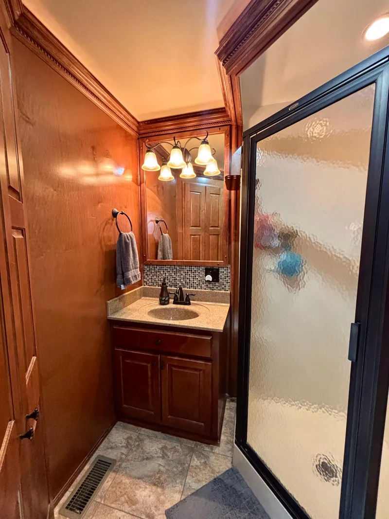 Slide: The Image of Luxurious bathroom in 2012 Horizon 16x66 model with wood accents and glass shower. - 38