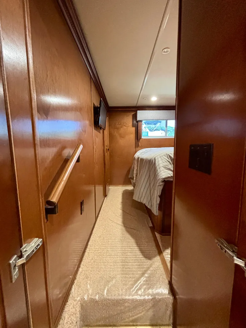 Slide: The Image of Cozy bedroom interior of 2012 Horizon 16x66 houseboat with wood paneling and bed. - 40