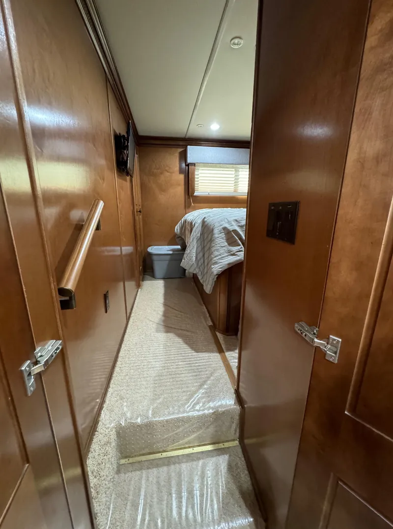 Slide: The Image of Interior hallway of 2012 Horizon 16x66 houseboat with wooden paneling and bedroom view. - 41