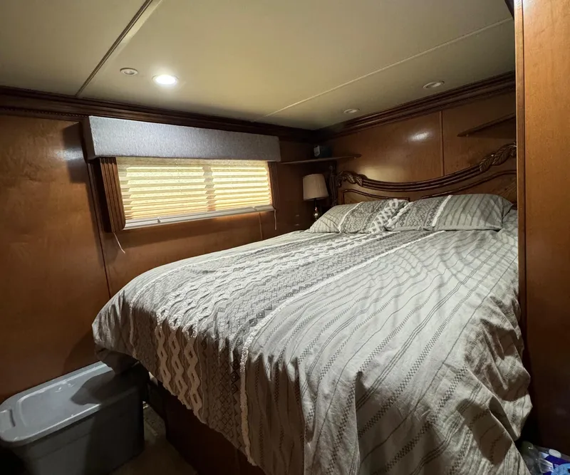 Slide: The Image of Cozy bedroom in 2012 Horizon 16x66 houseboat with wood paneling and patterned bedding. - 42