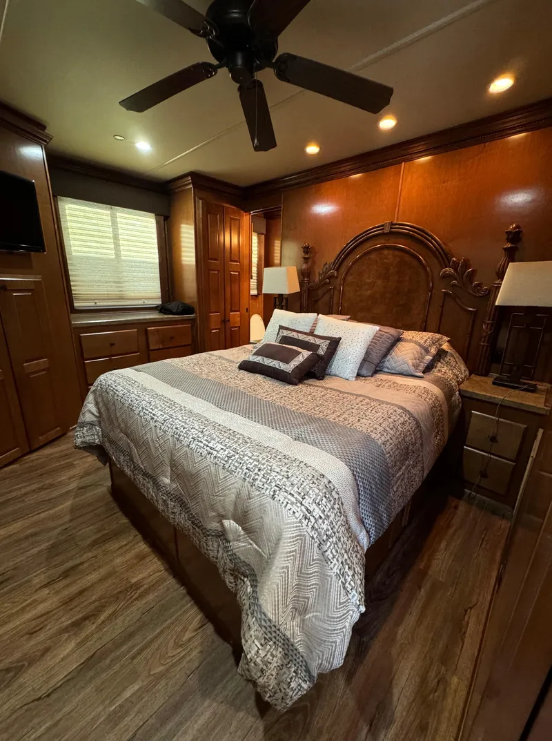 Slide: The Image of Luxurious bedroom in 2012 Horizon 16x66 houseboat with elegant wood furnishings and cozy bedding. - 44