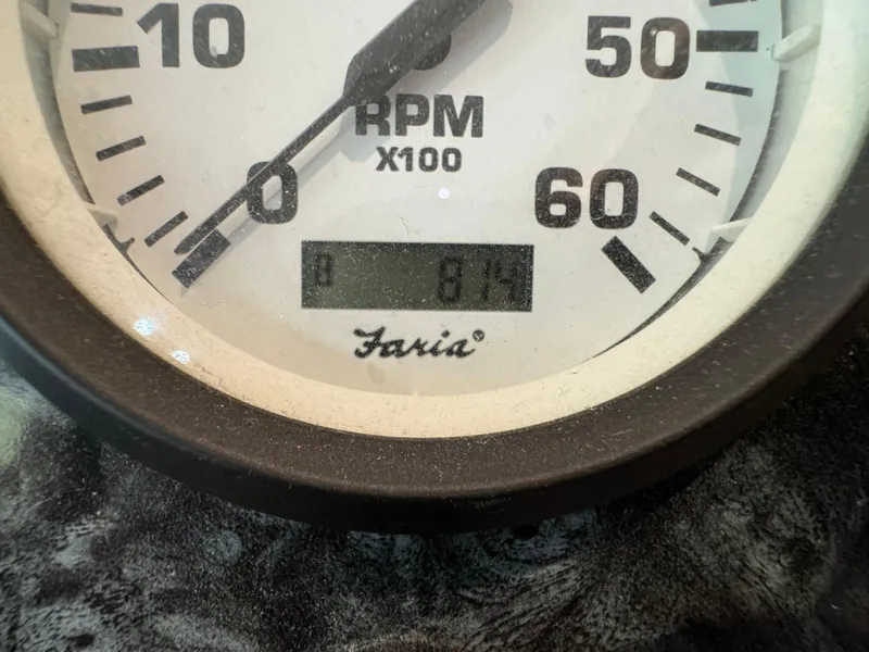Slide: The Image of Close-up of a Faria tachometer showing 874 RPM on a Horizon 16x66, 2012 model. - 48