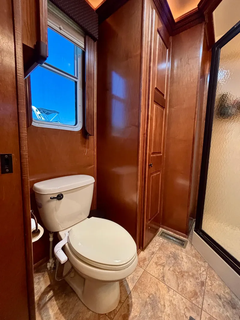 Slide: The Image of Luxurious bathroom in 2012 Horizon 16x66 houseboat with wooden cabinetry and modern fixtures. - 49