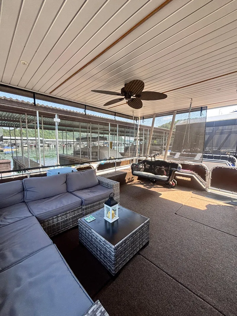 Slide: The Image of Spacious 2012 Horizon 16x66 houseboat deck with cozy seating and ceiling fan. - 5
