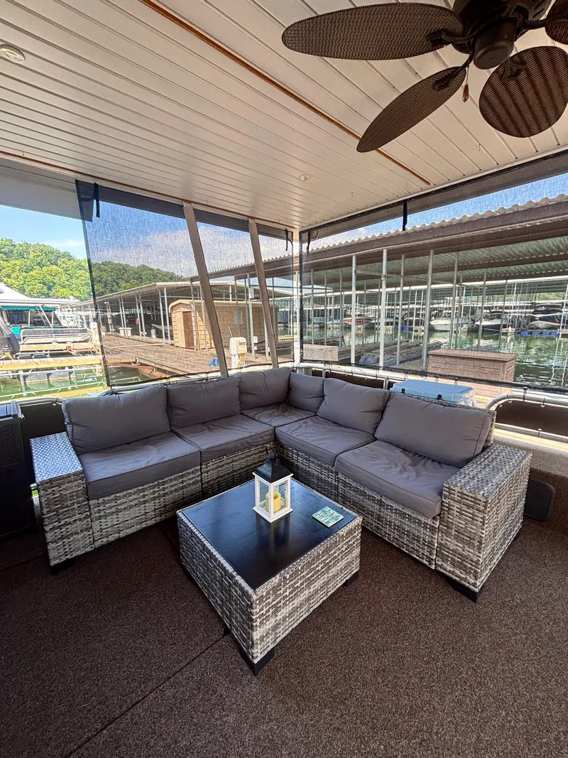 Slide: The Image of Luxurious 2012 Horizon 16x66 houseboat with cozy outdoor seating and scenic marina view. - 6