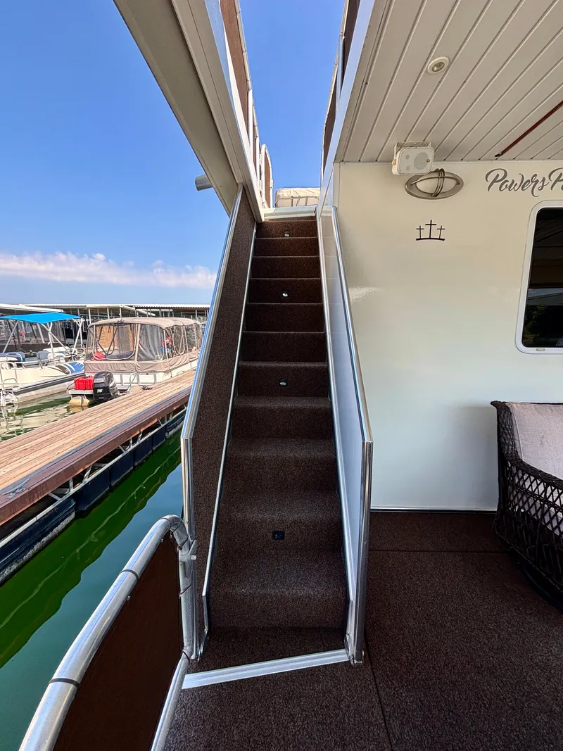 Slide: The Image of Staircase on 2012 Horizon 16x66 houseboat, leading to upper deck, docked at marina. - 9