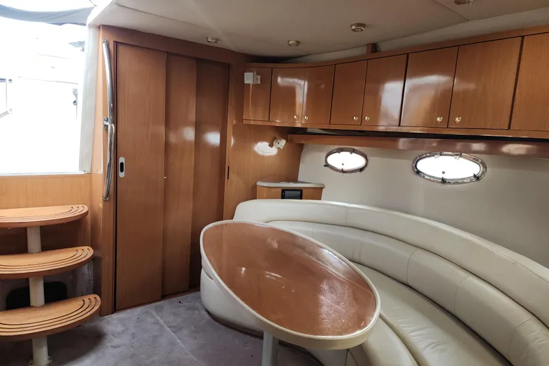 Slide: The Image of Interior of 2001 Regal Commodore 4160 yacht with wood cabinets and curved seating. - 5