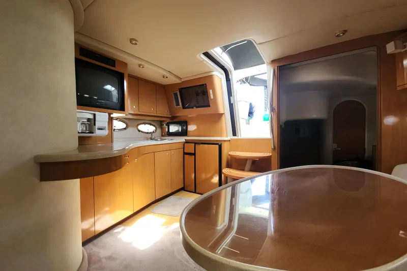 Slide: The Image of Interior of 2001 Regal Commodore 4160 yacht with kitchen and dining area. - 6
