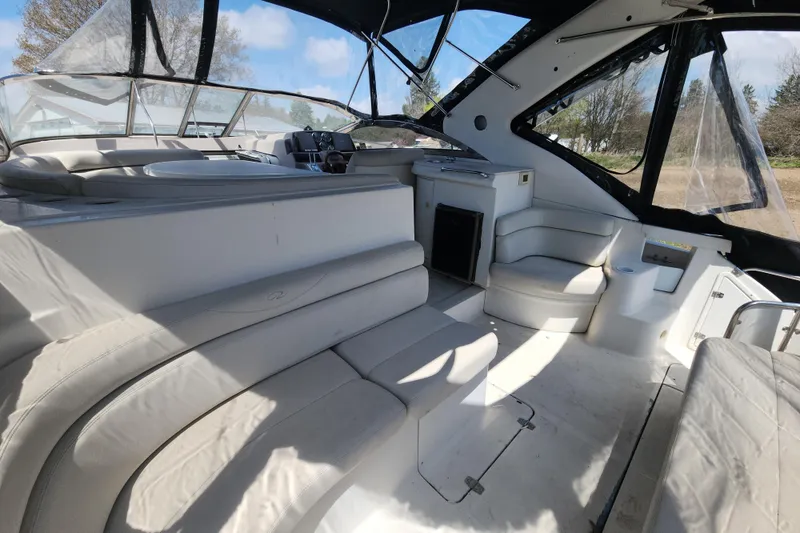 Slide: The Image of Interior of 2001 Regal Commodore 4160 yacht with white seating and helm. - 8