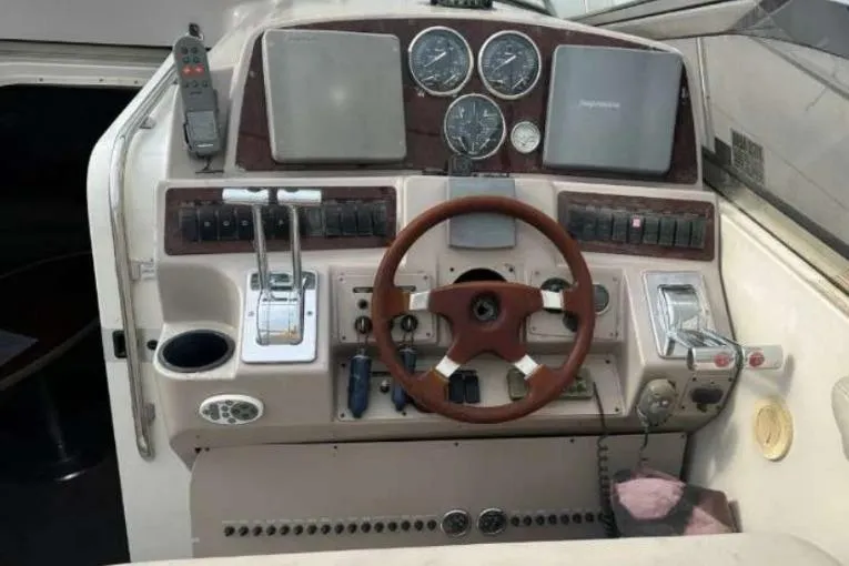 Slide: The Image of Control panel of a 2001 Regal Commodore 4160 boat with steering wheel and gauges. - 9