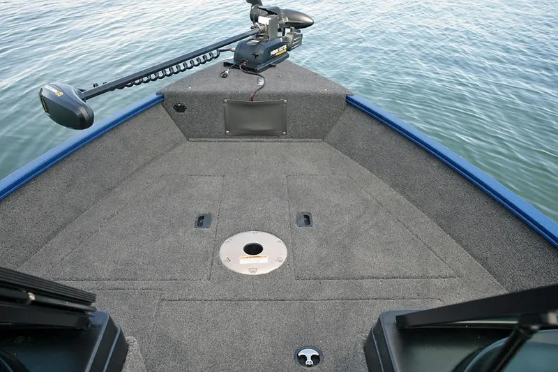 Slide: The Image of 2025 Lund 1650 Angler SS boat interior with steering wheel and seating. - 5