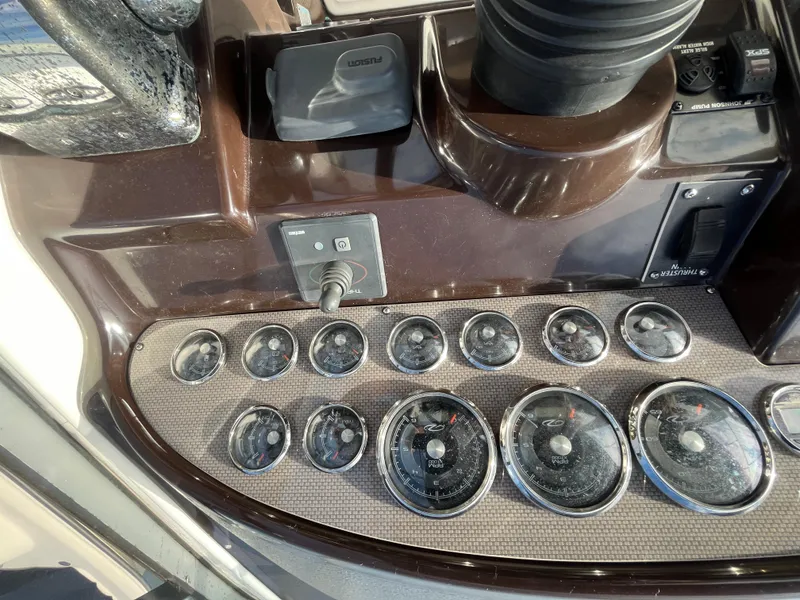Slide: The Image of Control panel of a 2013 Regal 30 Express boat with multiple gauges and switches. - 12