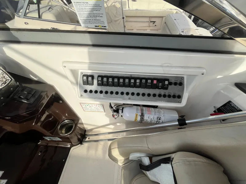 Slide: The Image of Control panel of a 2013 Regal 30 Express boat with fire extinguisher. - 13
