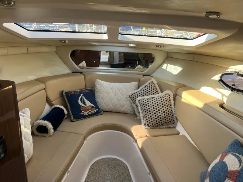 Slide: The Image of Luxurious interior of 2013 Regal 30 Express boat with plush seating and decorative pillows. - 16