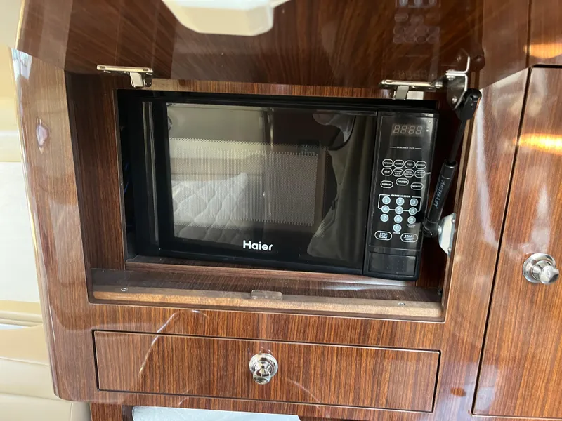 Slide: The Image of Haier microwave in 2013 Regal 30 Express yacht's wooden interior. - 21