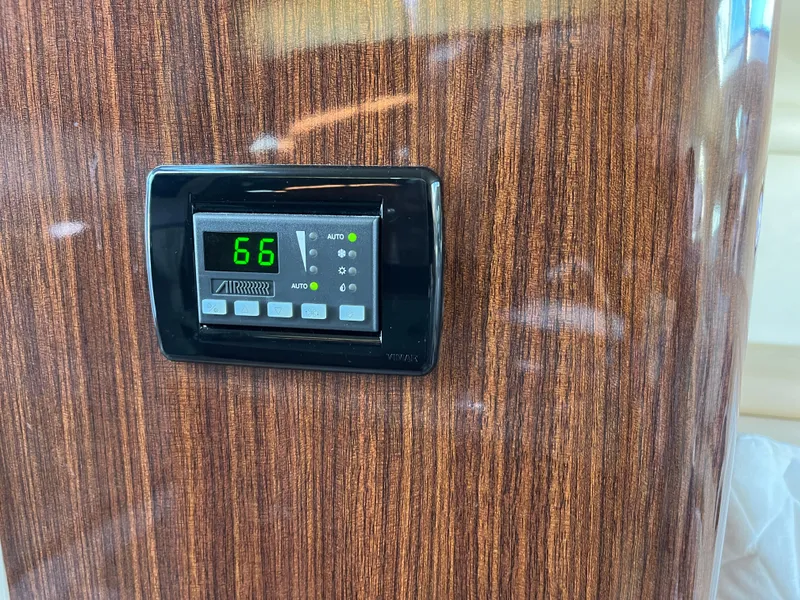 Slide: The Image of Thermostat on 2013 Regal 30 Express boat with wood paneling background. - 23