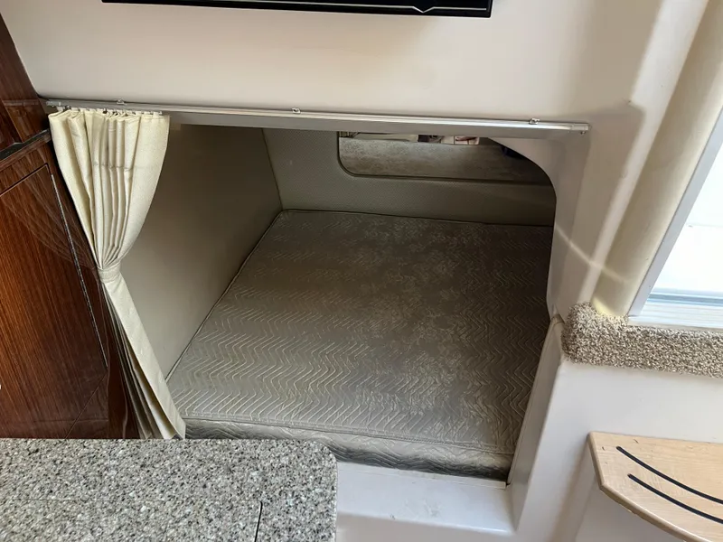 Slide: The Image of 2013 Regal 30 Express cabin interior with cozy sleeping area and curtain. - 24