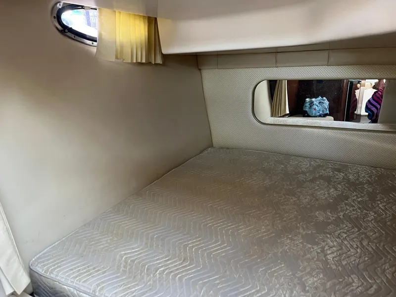 Slide: The Image of 2013 Regal 30 Express cabin interior with bed and window. - 26