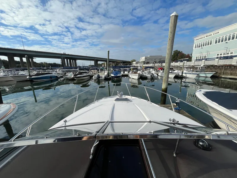 Slide: The Image of 2013 Regal 30 Express docked at marina under blue sky. - 27