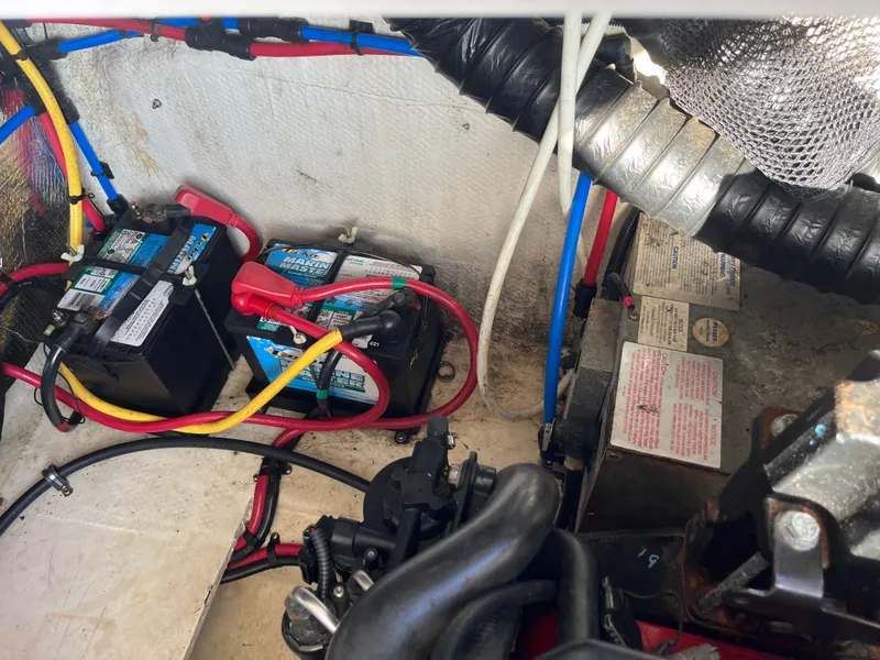 Slide: The Image of 2013 Regal 30 Express boat engine compartment with batteries and wiring. - 30
