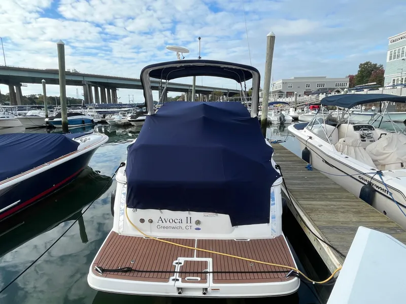 Slide: The Image of 2013 Regal 30 Express boat docked in marina with blue cover. - 4