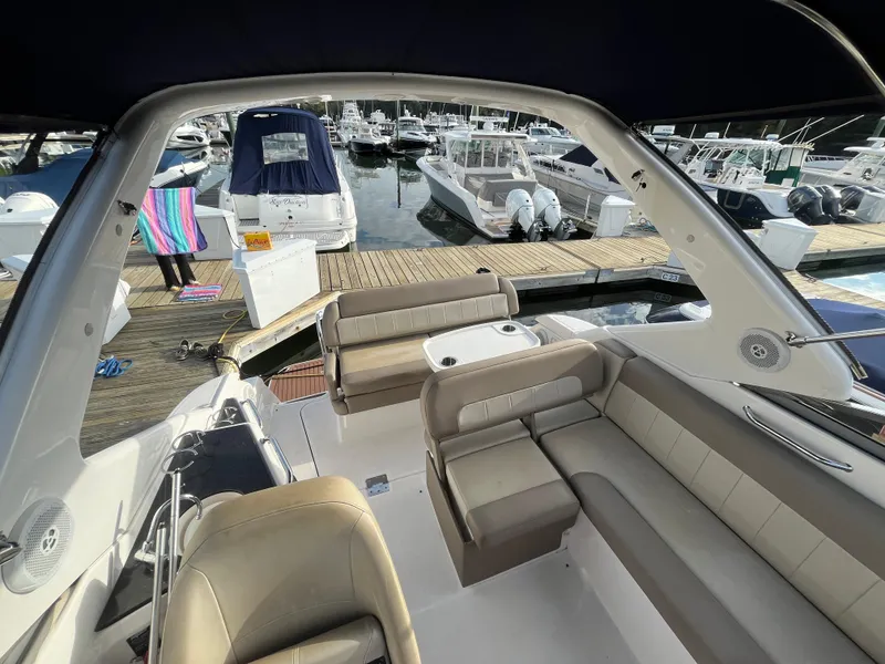Slide: The Image of 2013 Regal 30 Express boat interior with seating, docked at marina. - 6