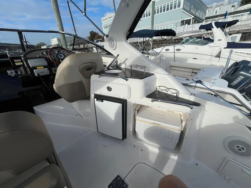 Slide: The Image of 2013 Regal 30 Express boat interior with seating and kitchenette area. - 7