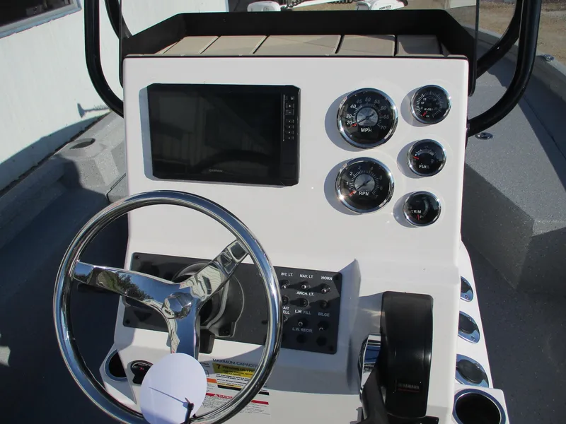 Slide: The Image of 2025 Vexus ACX 2150 boat dashboard with steering wheel and gauges. - 10