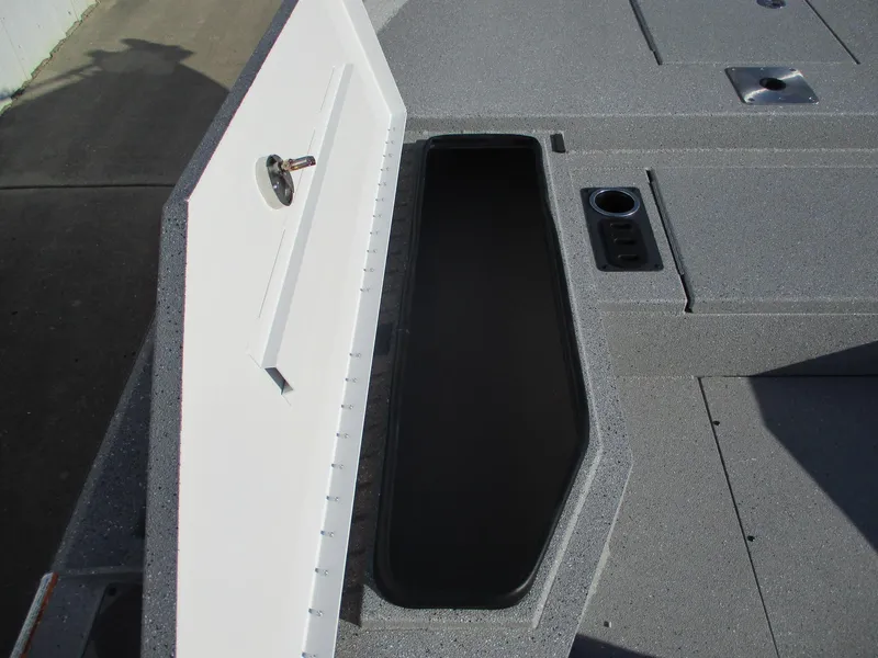 Slide: The Image of 2025 Vexus ACX 2150 boat storage compartment with open lid and cup holder. - 13