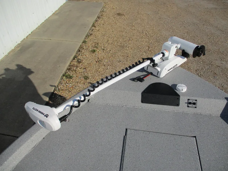 Slide: The Image of Vexus ACX 2150 boat with Minn Kota trolling motor, 2025 model, on a gravel surface. - 17