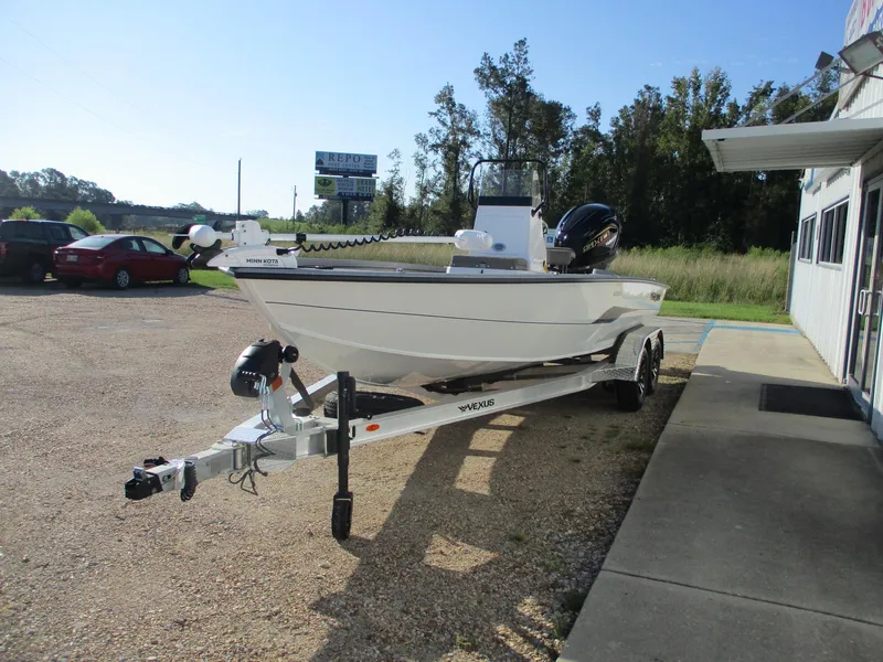 Slide: The Image of 2025 Vexus ACX 2150 boat on trailer, parked outdoors near a building. - 3