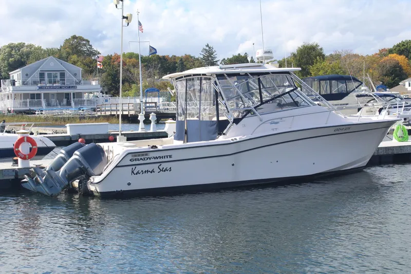 The Image of 2001 Grady-White Express 330 boat docked at marina with scenic background. - 0