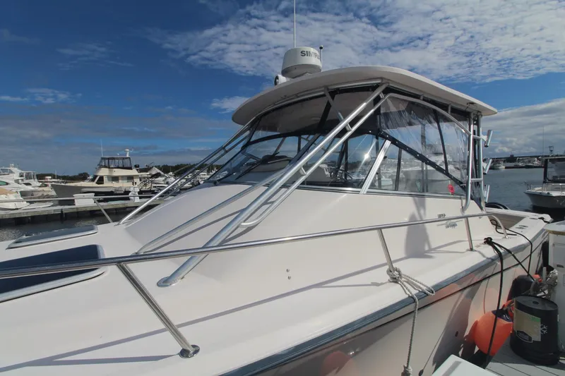 Slide: The Image of 2001 Grady-White Express 330 boat docked at marina under blue sky. - 10