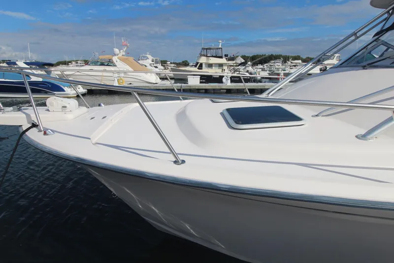 Slide: The Image of 2001 Grady-White Express 330 boat docked in a marina under a clear blue sky. - 11