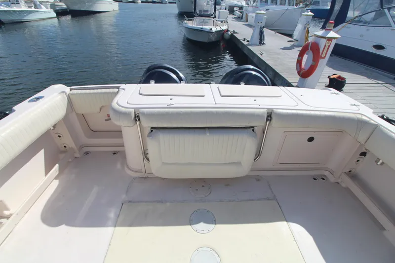 Slide: The Image of 2001 Grady-White Express 330 boat interior, docked at marina with visible seating and storage. - 12
