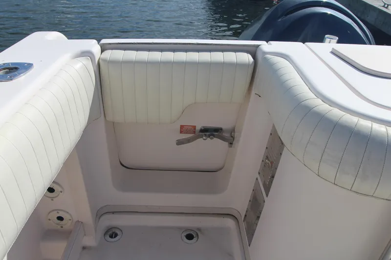 Slide: The Image of 2001 Grady-White Express 330 boat interior with cushioned seating and water view. - 13