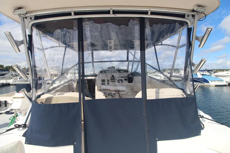 Slide: The Image of 2001 Grady-White Express 330 boat with enclosed cockpit, docked at marina. - 14