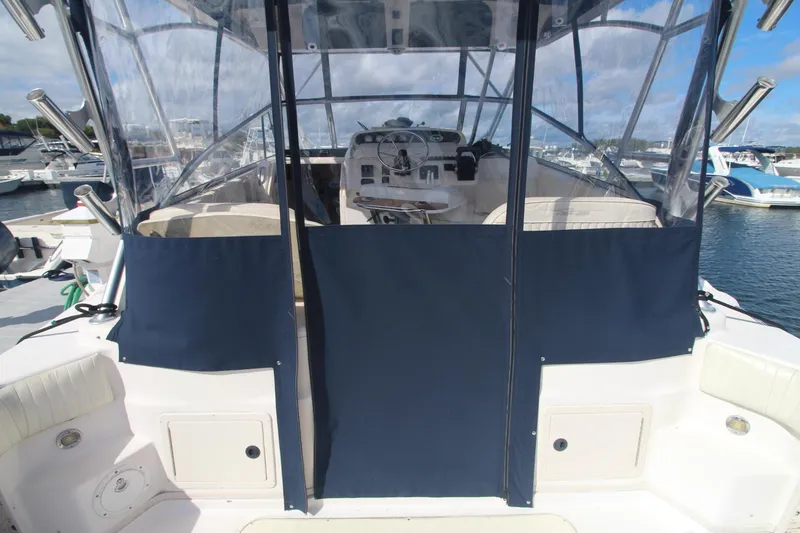 Slide: The Image of 2001 Grady-White Express 330 boat with covered cockpit, docked at marina. - 16