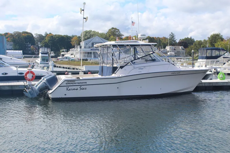 Slide: The Image of 2001 Grady-White Express 330 boat docked in a marina, side view. - 2