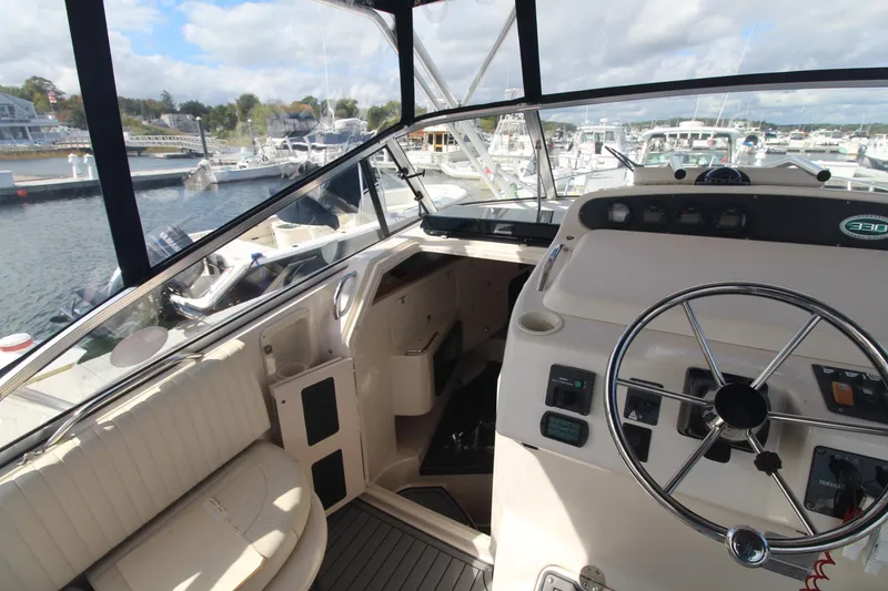 Slide: The Image of 2001 Grady-White Express 330 helm with steering wheel, docked in marina. - 21