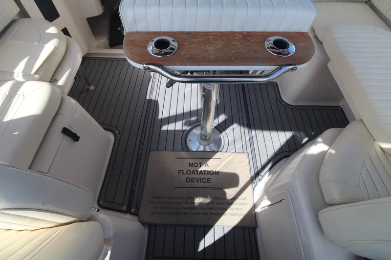 Slide: The Image of 2001 Grady-White Express 330 boat interior with seating and table, featuring a safety warning. - 23