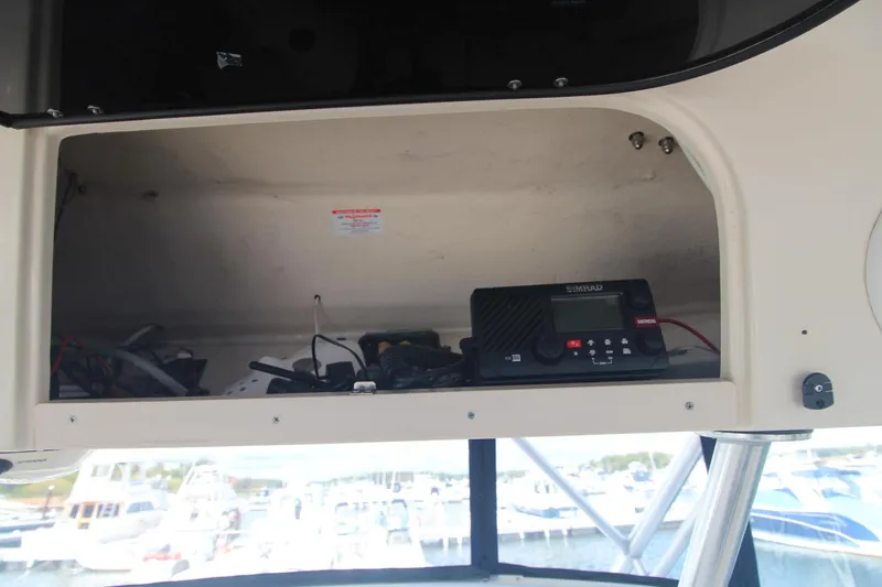 Slide: The Image of 2001 Grady-White Express 330 boat interior with storage compartment and electronic equipment. - 24