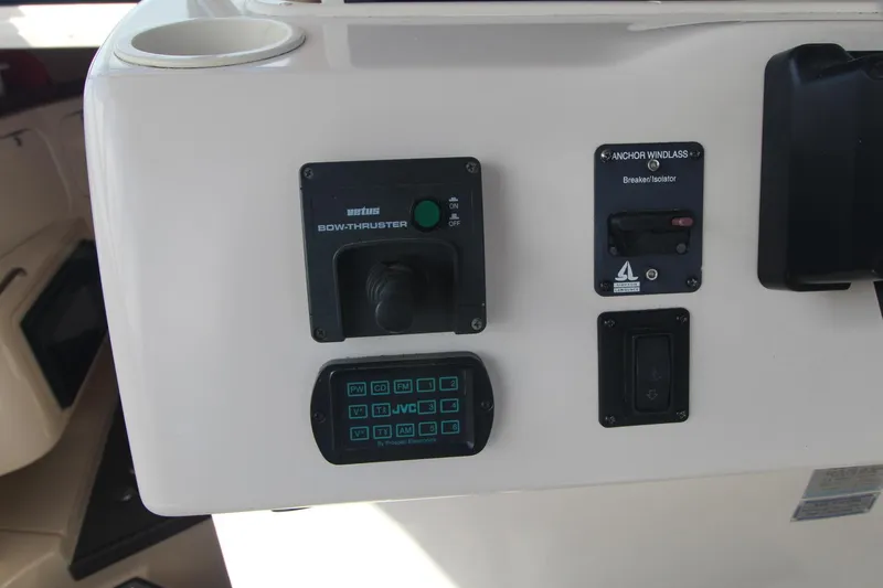 Slide: The Image of Control panel of a 2001 Grady-White Express 330 boat with various switches and buttons. - 25
