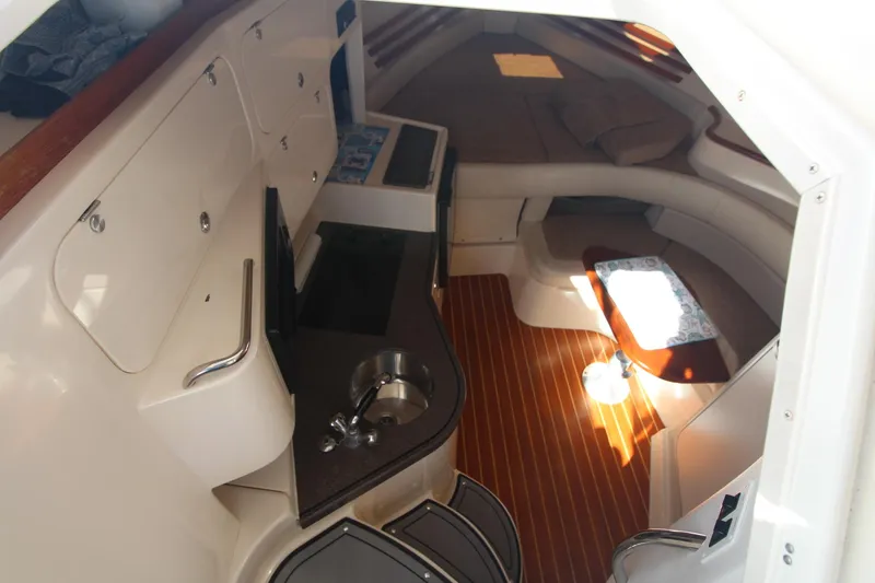 Slide: The Image of 2001 Grady-White Express 330 cabin interior with kitchenette and seating area. - 28