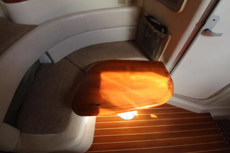 Slide: The Image of 2001 Grady-White Express 330 cabin interior with wooden table and cushioned seating. - 35